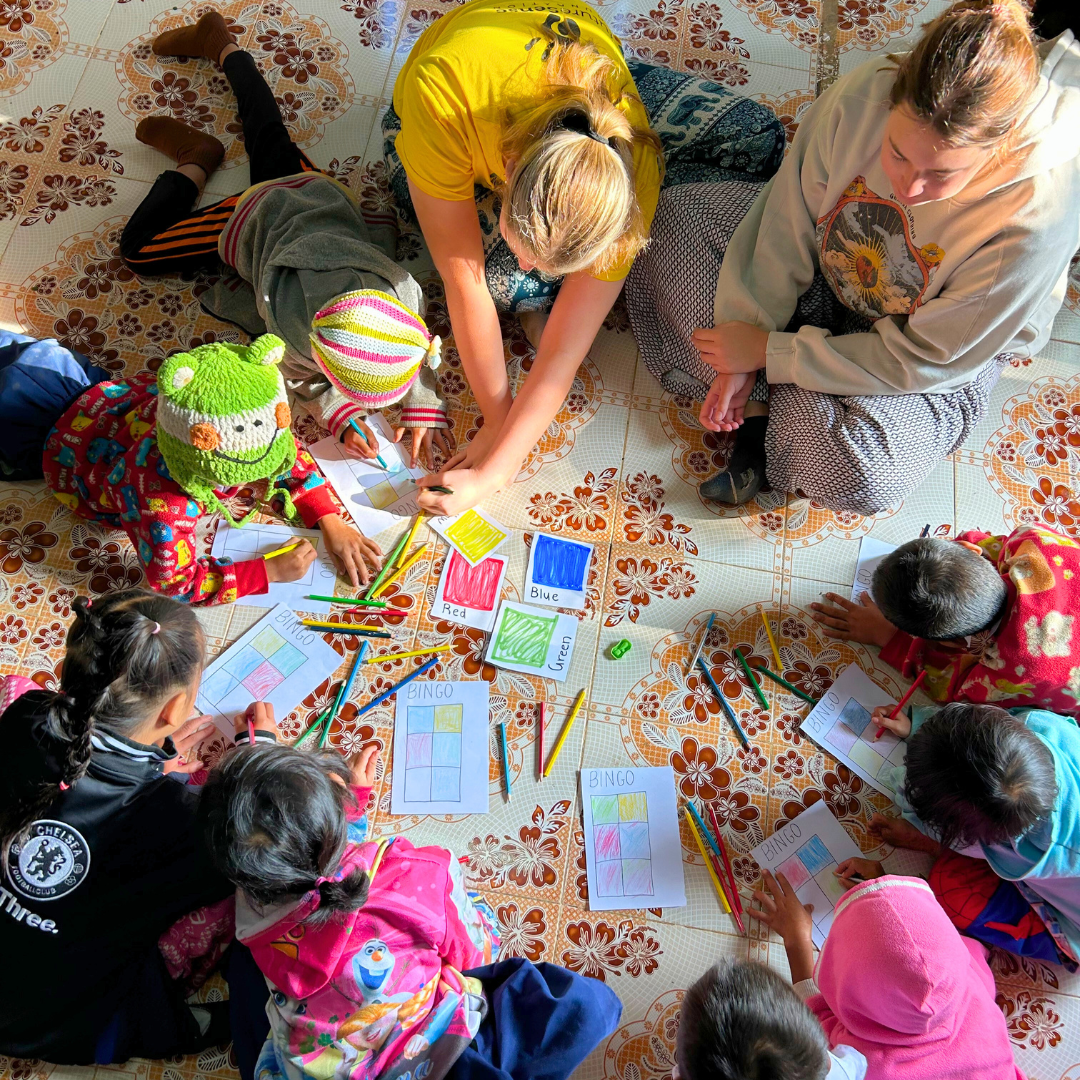 A group of school learners playing colour bingo